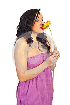 Young woman smelling a flower