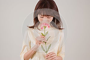 Young woman smelling flower