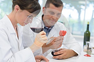young woman smelling white wine aroma at tasting