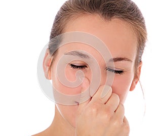 Young woman smells something awful photo