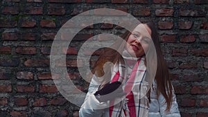 Young woman smile face on brick wall background