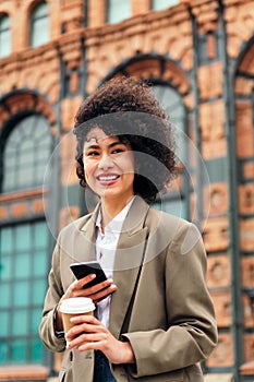 young woman smiles happy with a phone in the hand