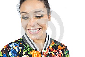 Portrait of girl looking down and with a beautiful make-up. Close up. Young woman wearing colorful clothes..