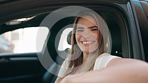 Young woman smiling confident driving car at street