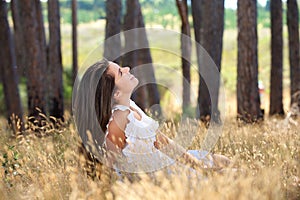 Young woman smiling in a countryside meadow