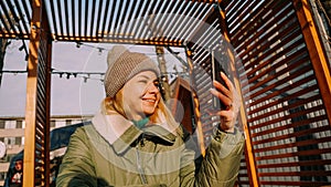 Young woman smiling doing selfie using smartphone at the city.