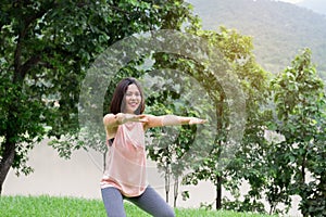 Young Woman Smiling exercising at the park. Healthy Lifestyle concept