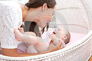 Young woman smiling with newborn infant