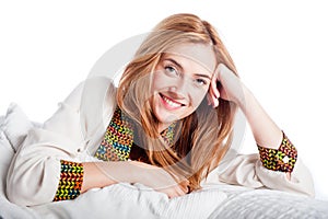 Young woman smiling and relaxing on a sofa