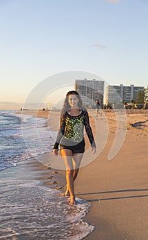 Young Woman Smiling While Walking on the Beach