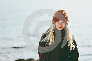 Young Woman smiling walking at winter sea Travel Fashion Lifestyle concept outdoor