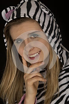 Young woman smiling wearing black and whit striped pajamas