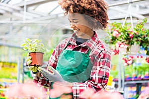 Young woman smiling during work at a modern flower market