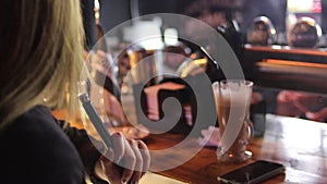 Young woman smokes a hookah at the bar