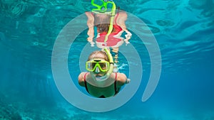 Young woman in snorkeling mask dive underwater with tropical fishes