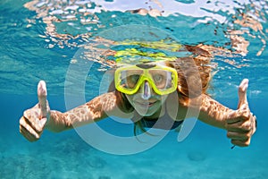 Young woman in snorkeling mask dive underwater with tropical fishes