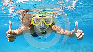 Young woman in snorkeling mask dive underwater with tropical fishes