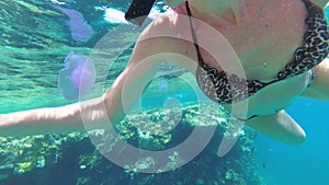 Young Woman with Snorkeling Mask and Tube Swimming in Red Sea near Coral Reef