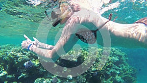 Young Woman with Snorkeling Mask and Tube Swimming in Red Sea near Coral Reef