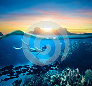 Woman snorkeling in clear tropical waters ocean on sunset day