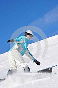 Young woman snowboarding