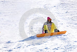 Young woman snowboarding on hill. Winter