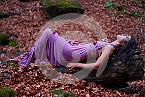 Young woman in soaked wet purple dress