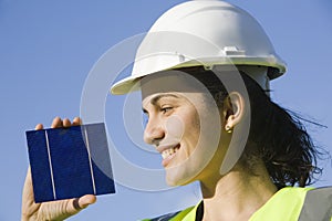Young woman with a solar cell
