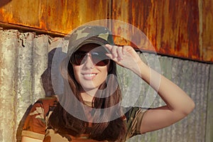 Young Woman Soldier in Camouflage Outfit Saluting