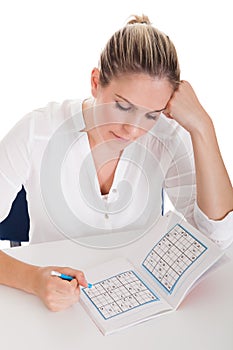 Young Woman Solving Sudoku