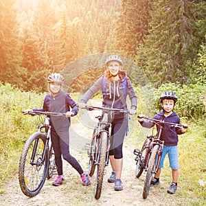 Young woman with son and daughter enjoying cycling