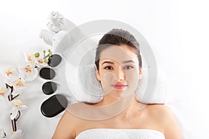Young woman and spa accessories on white background, top view