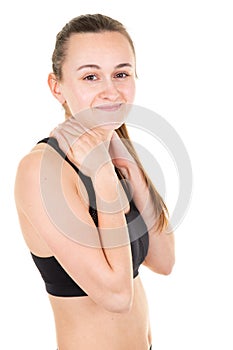 Young woman sport trainer with slim body in sport clothes hands on neck in white background