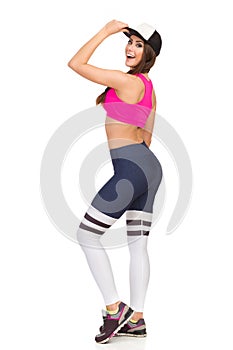 Happy Woman In Sports Clothes And Cap Is Looking Over Shoulder And Talking