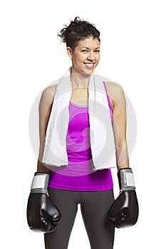 Young woman in sports outfit wearing boxing gloves