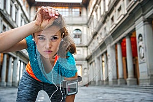 Young woman in sportswear is catching breath