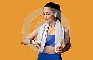 Young Woman In Sportswear Checking Activity Tracker