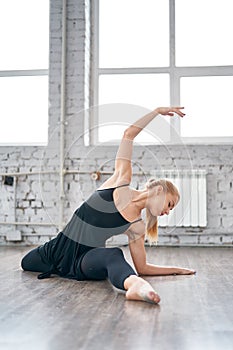 Young woman in sportswear doing stretching