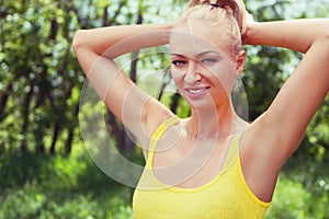 Young woman in sportswear standing outdoors in a park