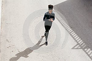 Young woman in sportswear walking on street