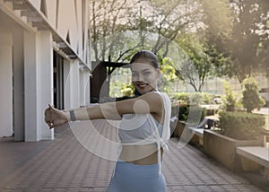 Young woman with sportwear.raise hands up beside hre body for stretching,prepare for exercise photo