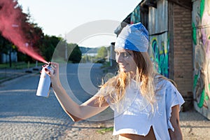 Young woman spray paint artist