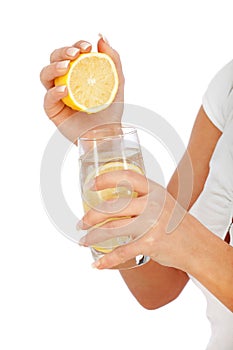 Young woman squeezing lemon