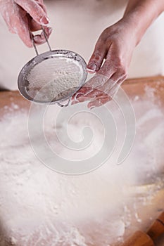 Young woman squirting a flour in an apron