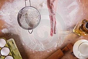 Young woman squirting a flour in an apron