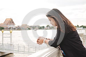 Young woman stand alone on riverside and she looking scenery vie