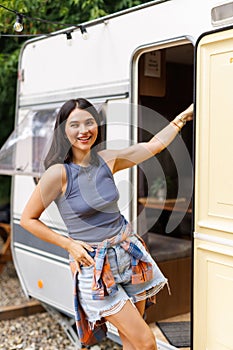 Young woman stand in front of motorhome