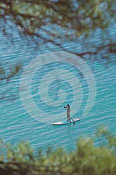 Young Woman Stand Up Paddle Boarding