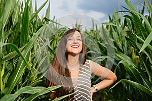 Young woman standinfgin the corn field