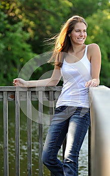 young woman standing against railing